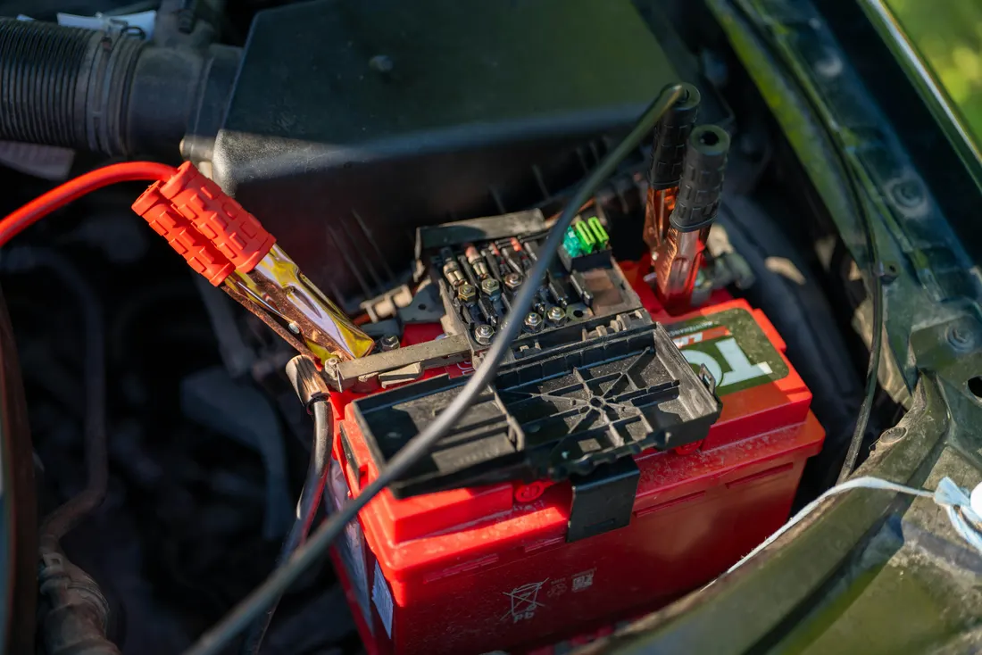 Battery, starter & alternator repair — close-up of a car battery in the engine bay