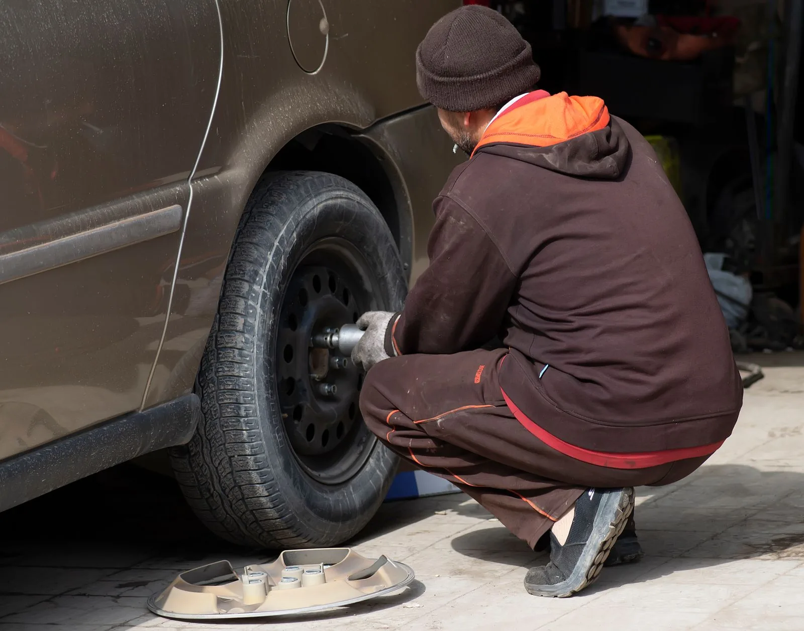 Steering & suspension repair — suspension components viewed from below on a lift